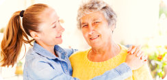 caregiver and elderly woman smiling