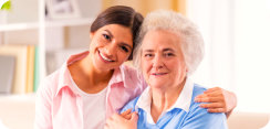 caregiver and elderly woman smiling