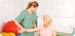 nurse and elderly woman doing physical therapy