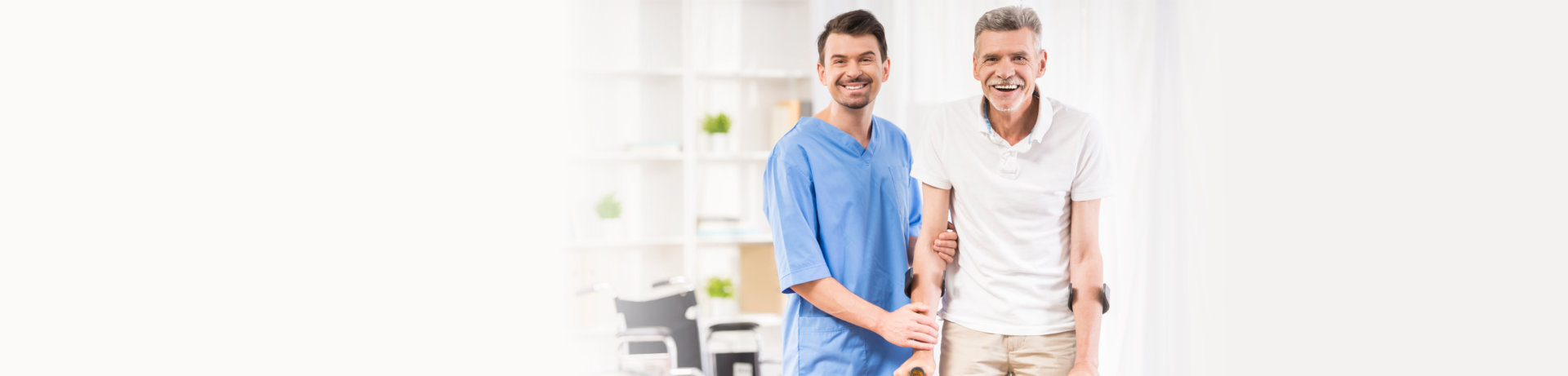 caregiver and elderly man smiling