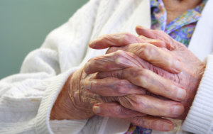 senior holding hands together